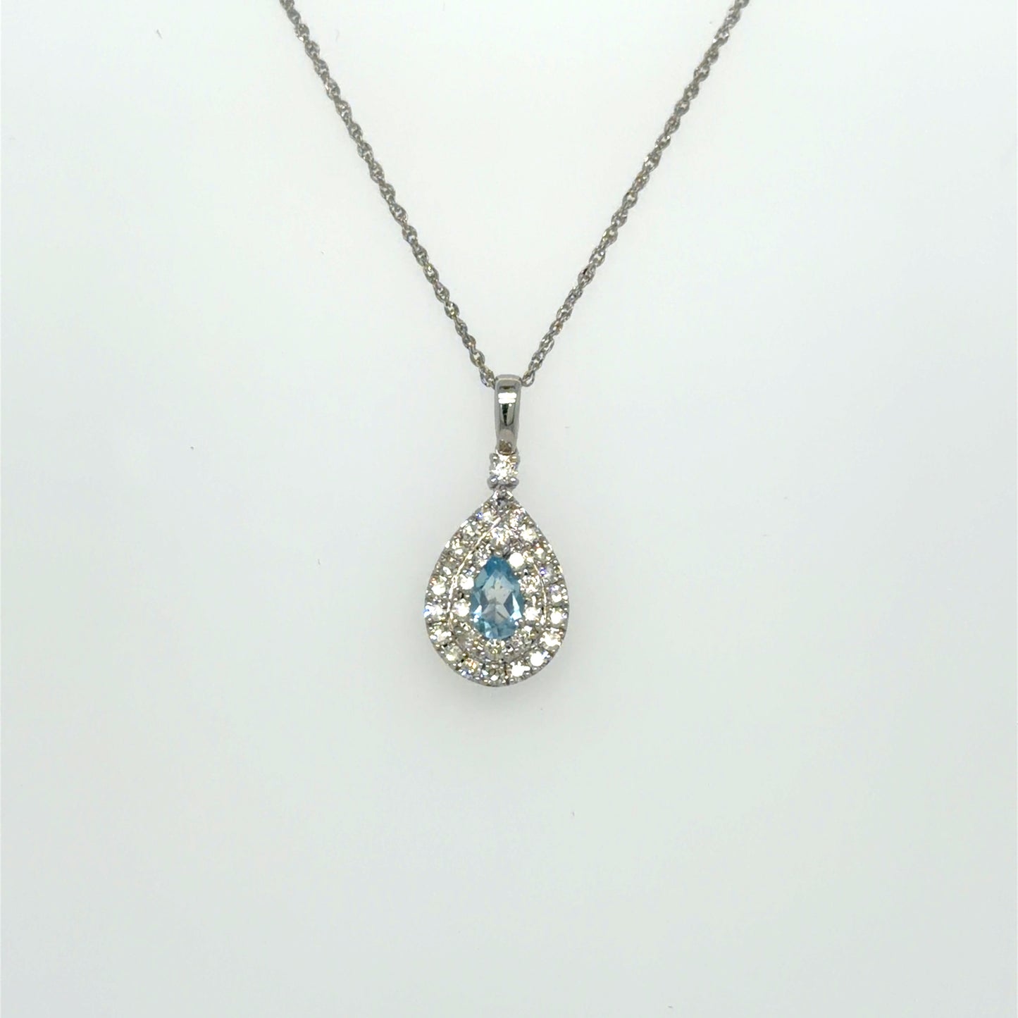 0.26 CT Sky Blue Topaz & Natural Diamond Halo Pendant in 14K White Gold