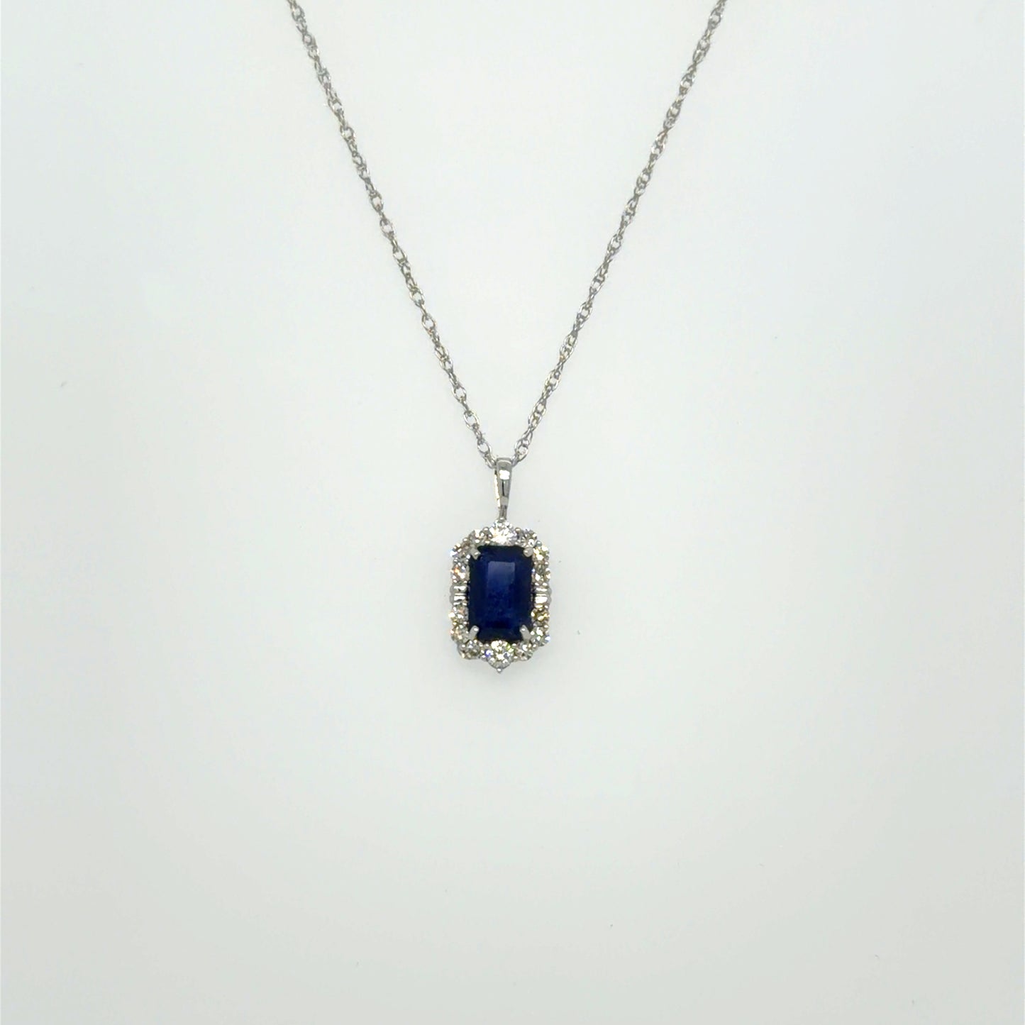 0.65 CT Sapphire & Natural Diamond Halo Pendant in 10K White Gold